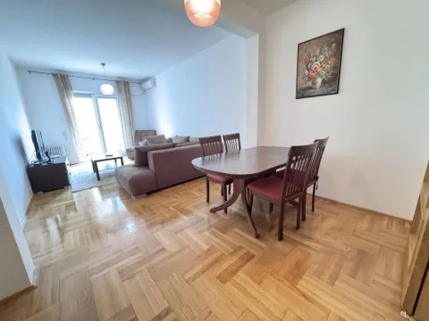 Living room with dining area and parquet flooring. - image 4