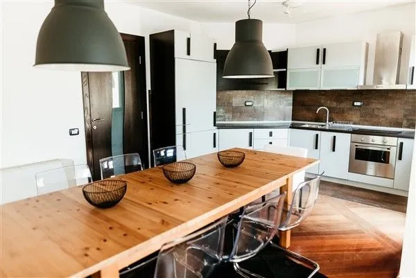 Bright and modern kitchen with a large dining table.