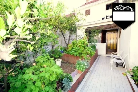 Yard in front of the house with a tiled walkway and greenery. - image 12
