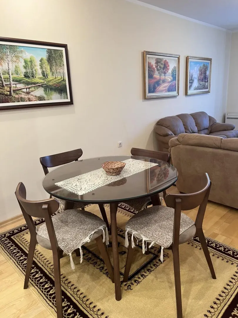 Dining table with chairs in the living room area.