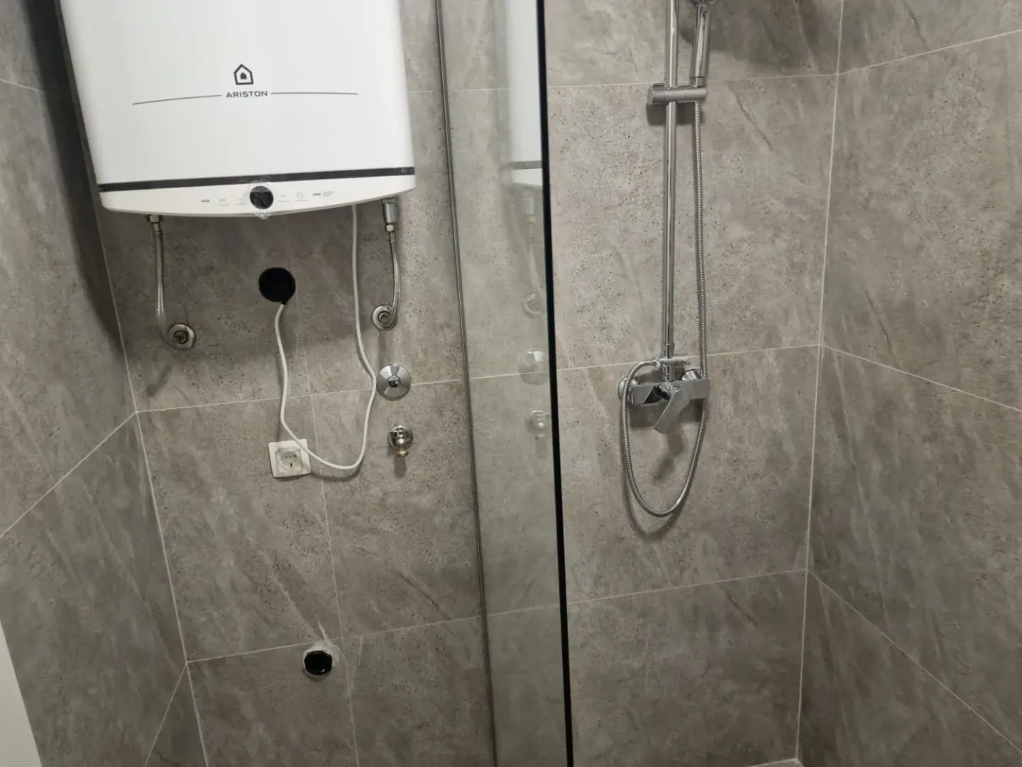 Modern tiles and shower cabin in the bathroom.