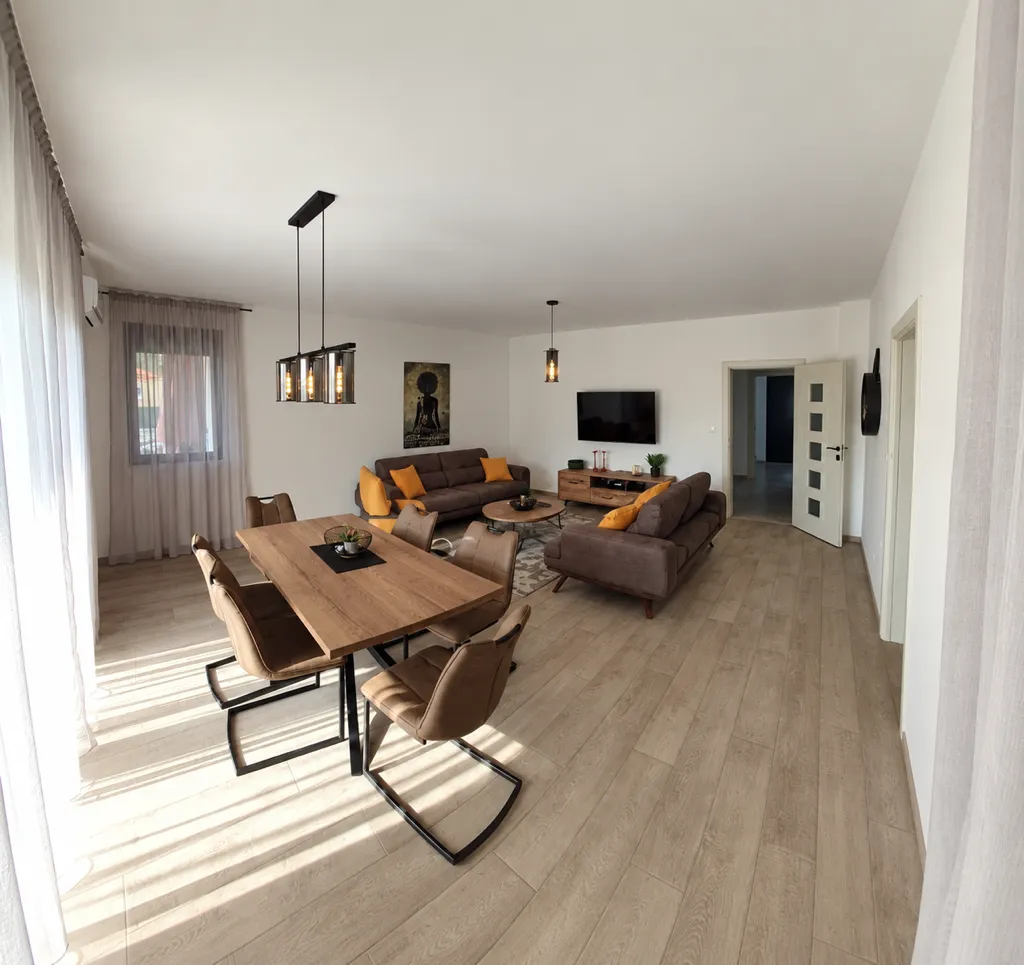 Spacious living room with dining area and modern furniture.