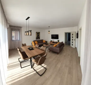 Spacious living room with dining area and modern furniture. - image 12