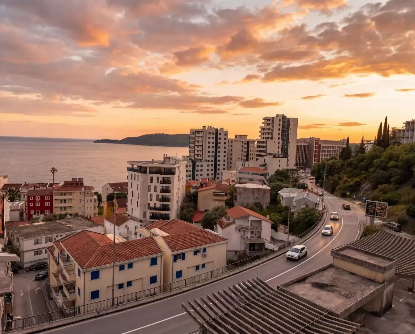 View of the city, coast, and sea at dusk.