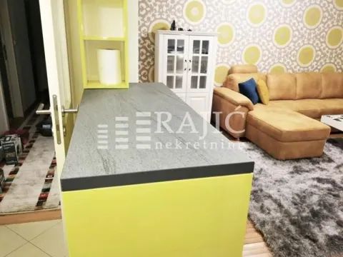 Living room with a sofa set and a counter in the foreground. - image 3