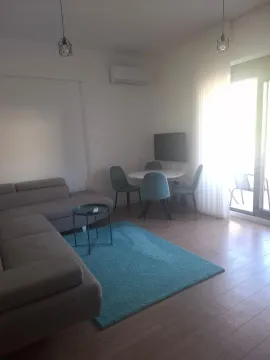 Living room with a sofa, dining table, and access to the terrace. - image 2