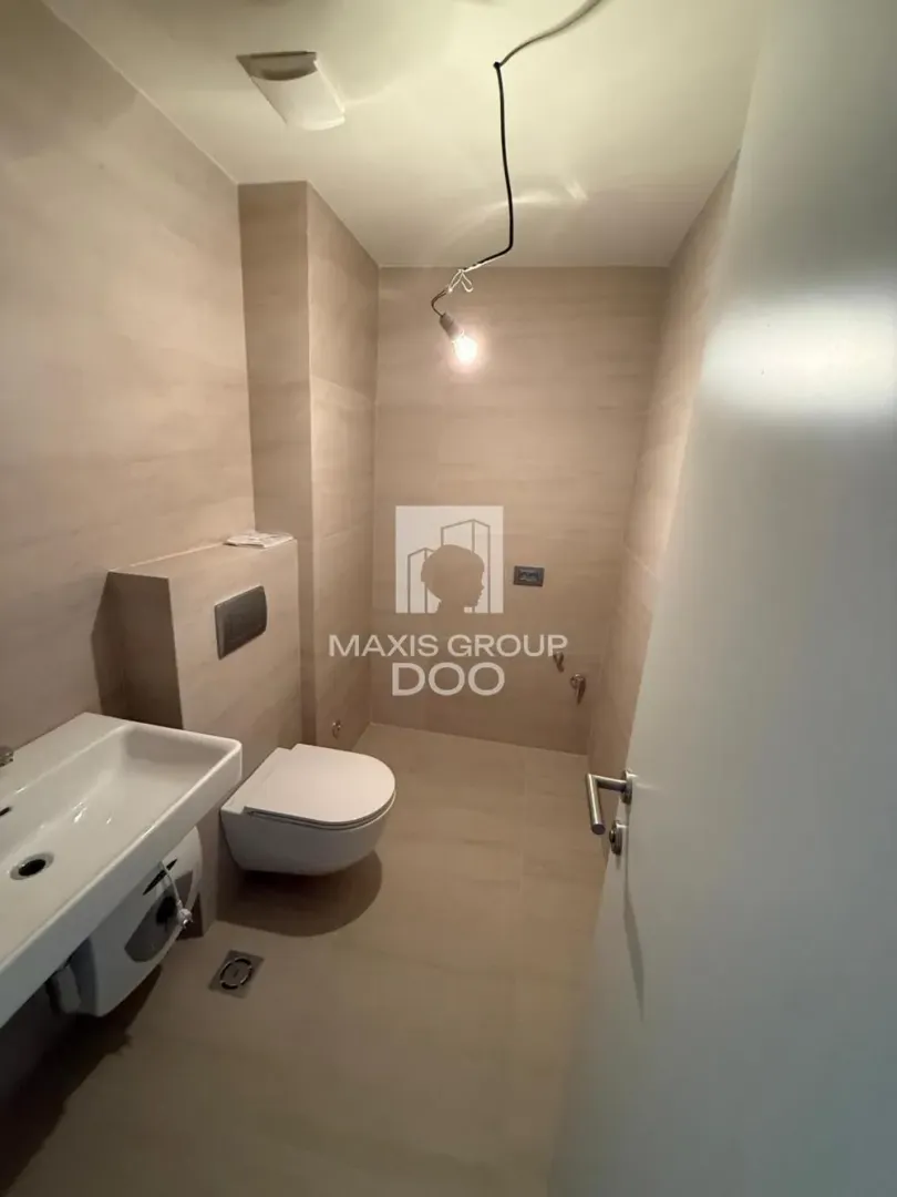 Small bathroom with sanitary ware and beige tiles.