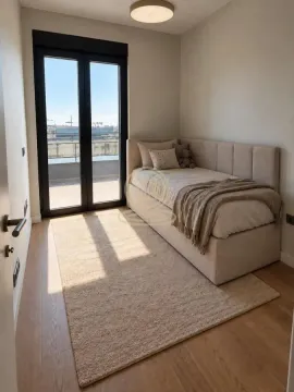 Smaller bedroom with a bed and access to the terrace. - image 5
