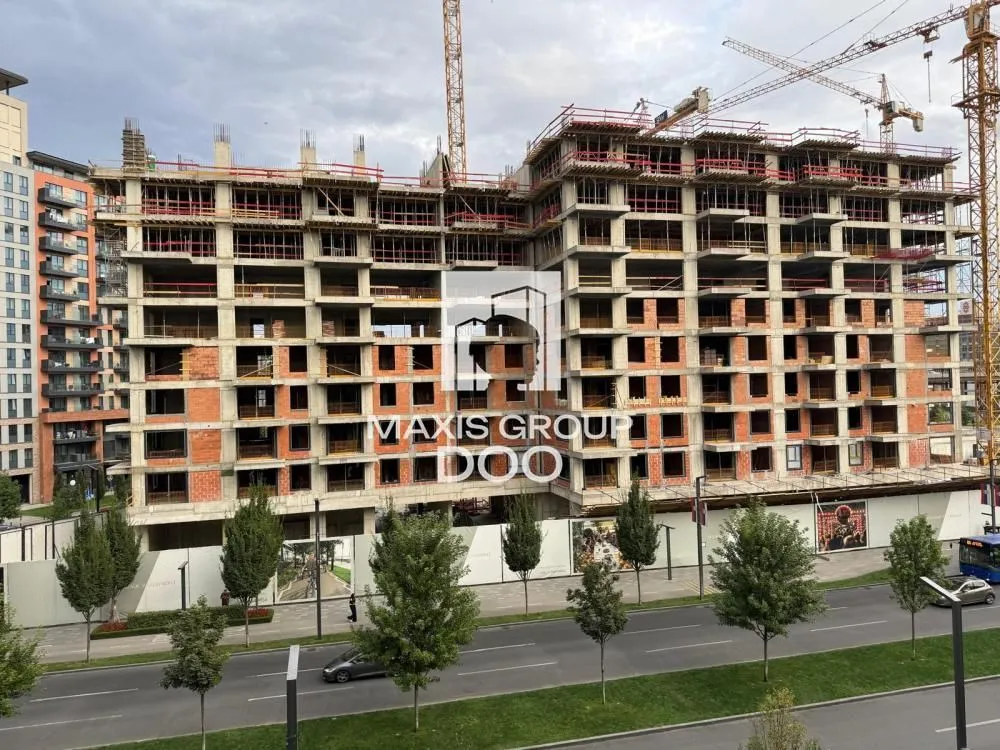 View of a multi-story building under construction with a concrete structure.