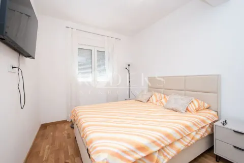 Bedroom with a double bed, bedside table, and a wall-mounted TV. - image 5