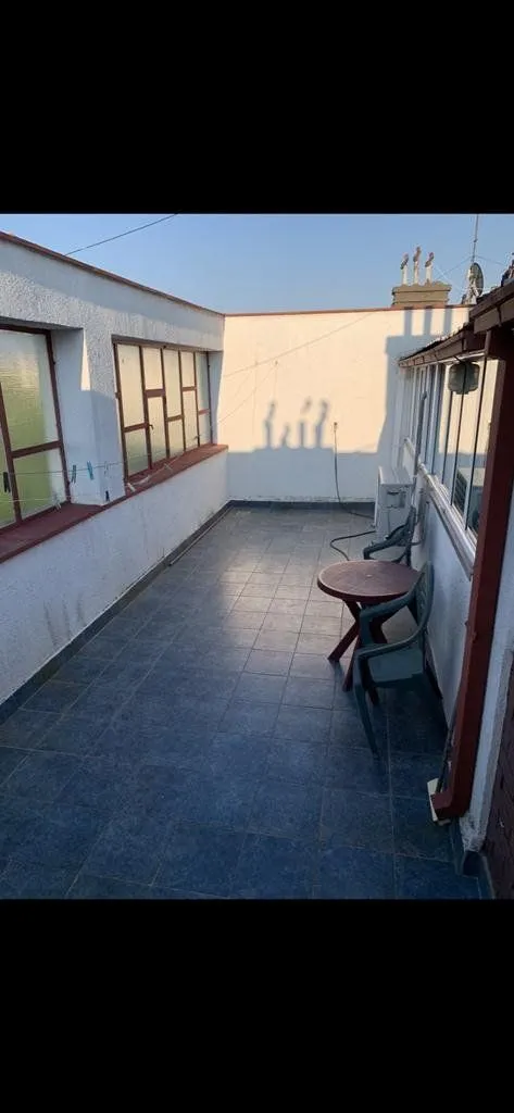 Spacious tiled terrace with outdoor seating.