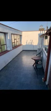 Spacious tiled terrace with outdoor seating. - image 11