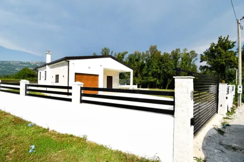 View of the exterior of the house with a fence and yard. - image 3