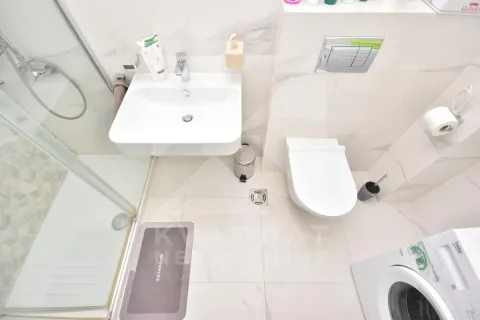 Top-down view of a modern bathroom equipped with a shower cabin, washbasin, and toilet. - image 8