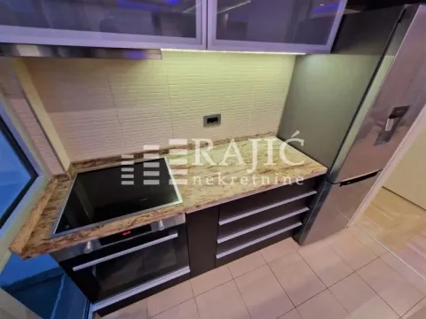 Modern kitchen with built-in appliances and cabinetry. - image 20