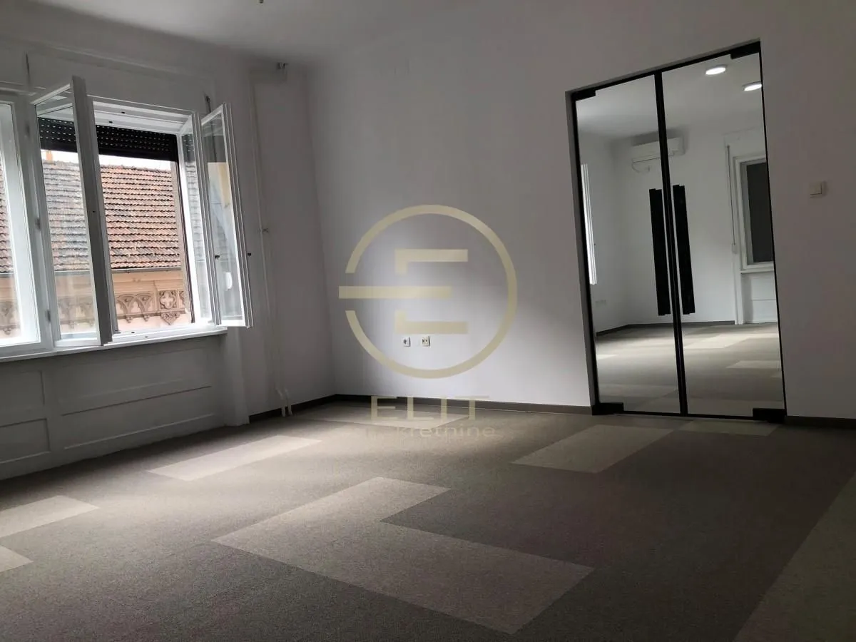 Empty room with a window and glass sliding doors.
