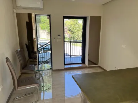 Living room with a glass table, chairs, and access to the terrace. - image 7