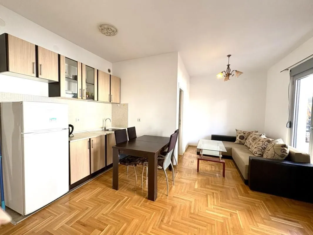 Living room with kitchen and dining area.