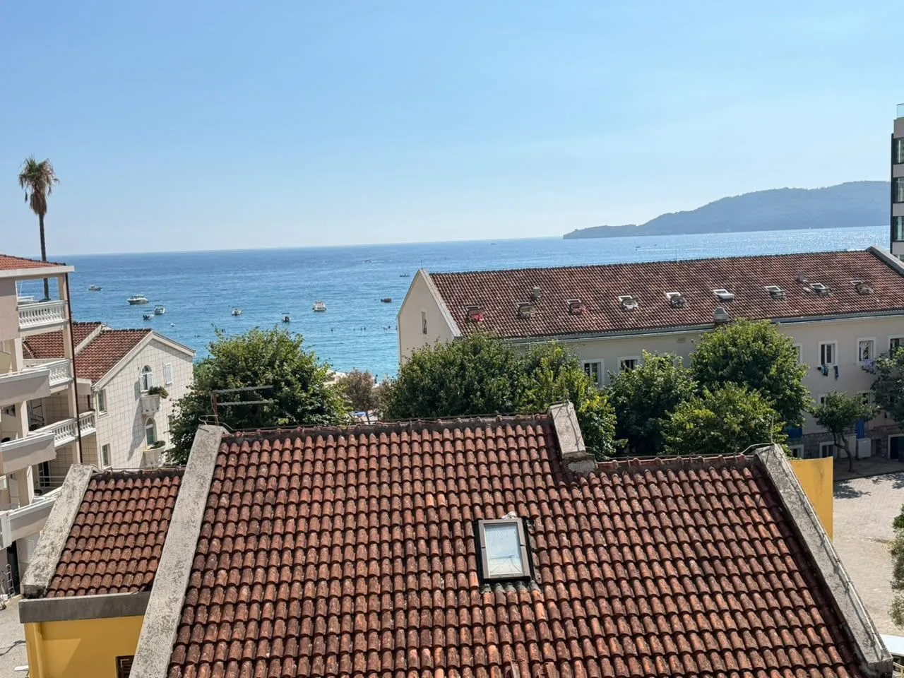 View of the sea and surrounding rooftops from the terrace.