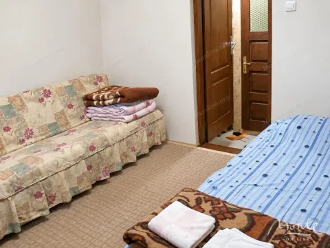 Furnished bedroom with a bed and a sofa. - image 5