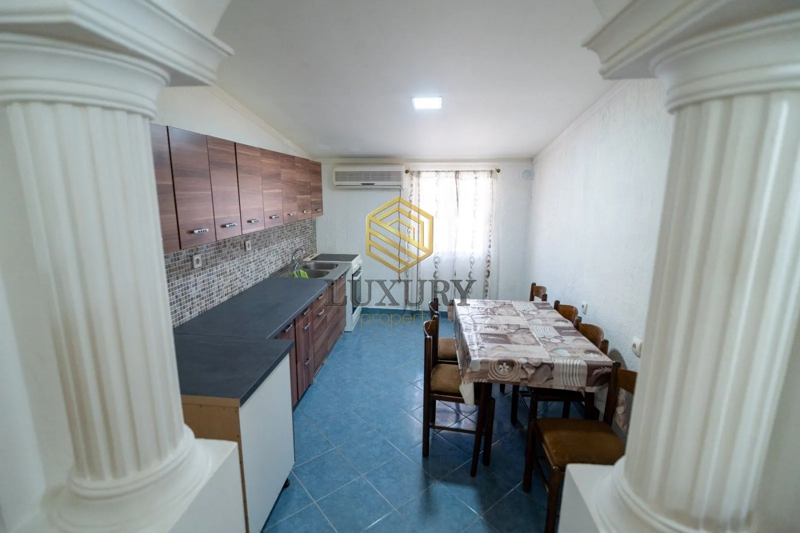 Kitchen with dining area and wooden cabinets.