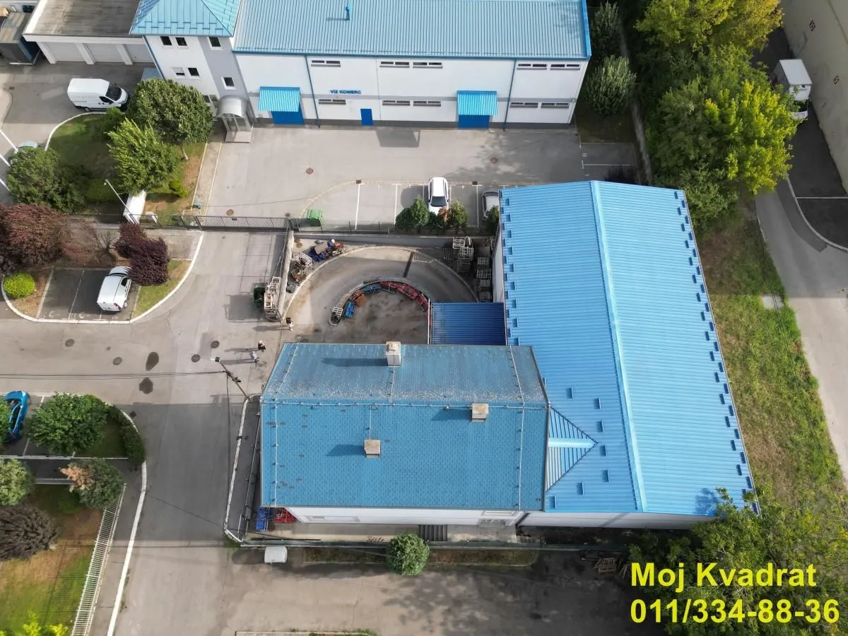 Aerial view of the building exterior with a blue roof and courtyard.
