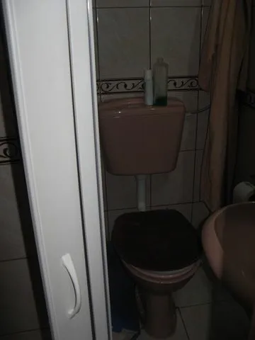 A small bathroom with a toilet.
