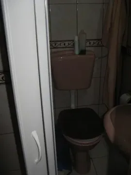 A small bathroom with a toilet. - image 8
