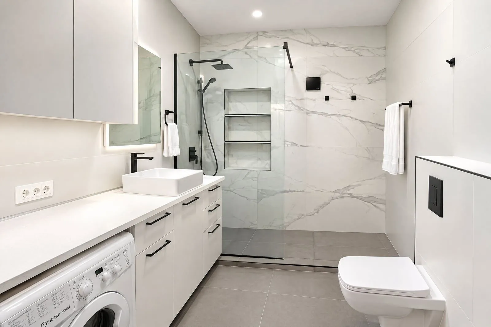 Modern bathroom with a walk-in shower and white furniture.