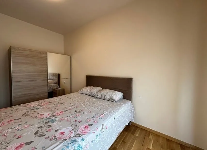Bedroom with a double bed and a mirrored wardrobe.