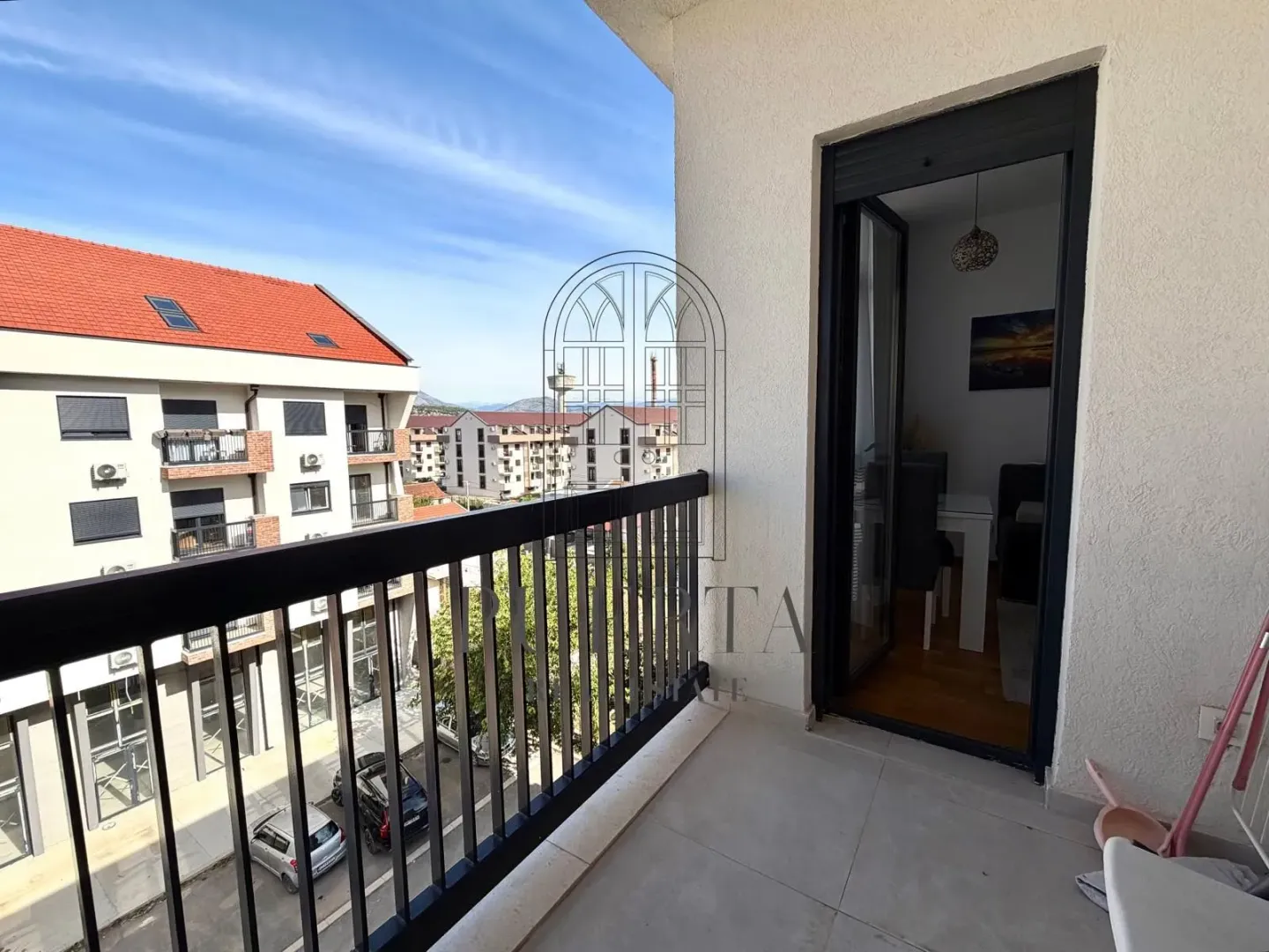 Bright apartment with a view of surrounding buildings and the city street.