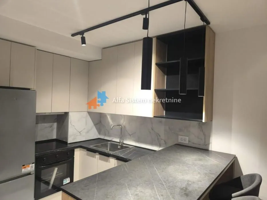 Modern kitchen with built-in appliances and a breakfast bar.