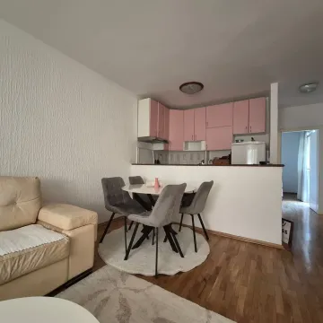 Living room with dining area and kitchen in the background. - image 3