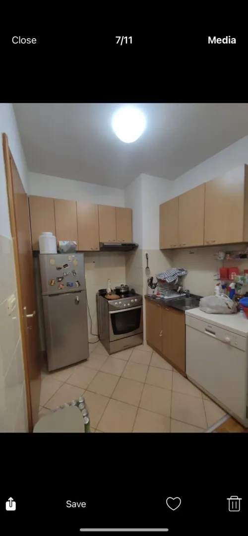 A simple kitchen with wooden cabinets and appliances.