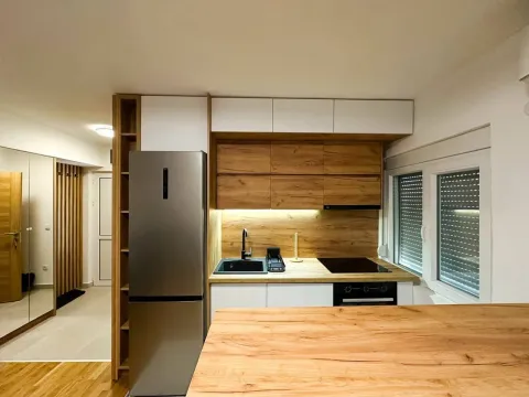 Modern kitchen with wooden elements and built-in appliances. - image 8