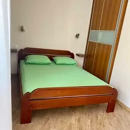 Bedroom with a double bed and a wooden wardrobe.