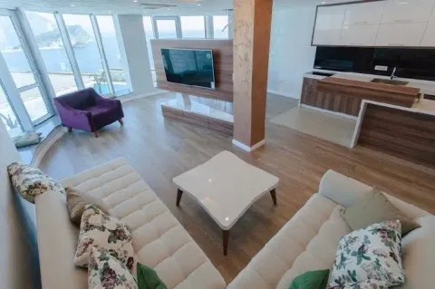 Spacious living room connected to the kitchen, with large windows and a sea view. - image 3