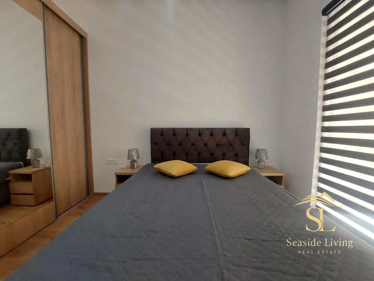 Furnished bedroom with a double bed and wardrobe.