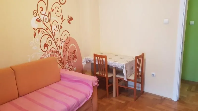 Living room with a sofa and a dining table.
