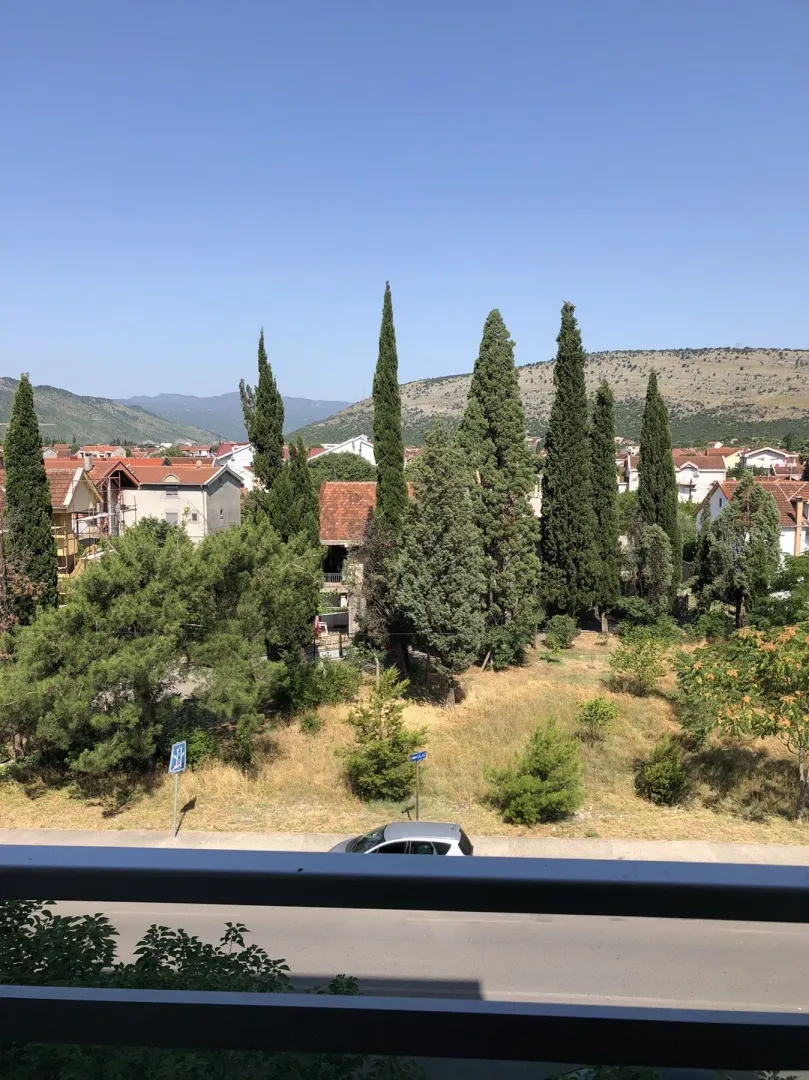 View from the terrace of the surrounding greenery and houses in the distance.