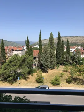 View from the terrace of the surrounding greenery and houses in the distance. - image 19