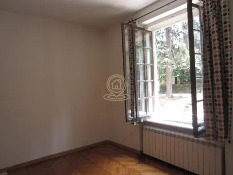 Empty room with wooden parquet flooring and an open window overlooking the yard. - image 16