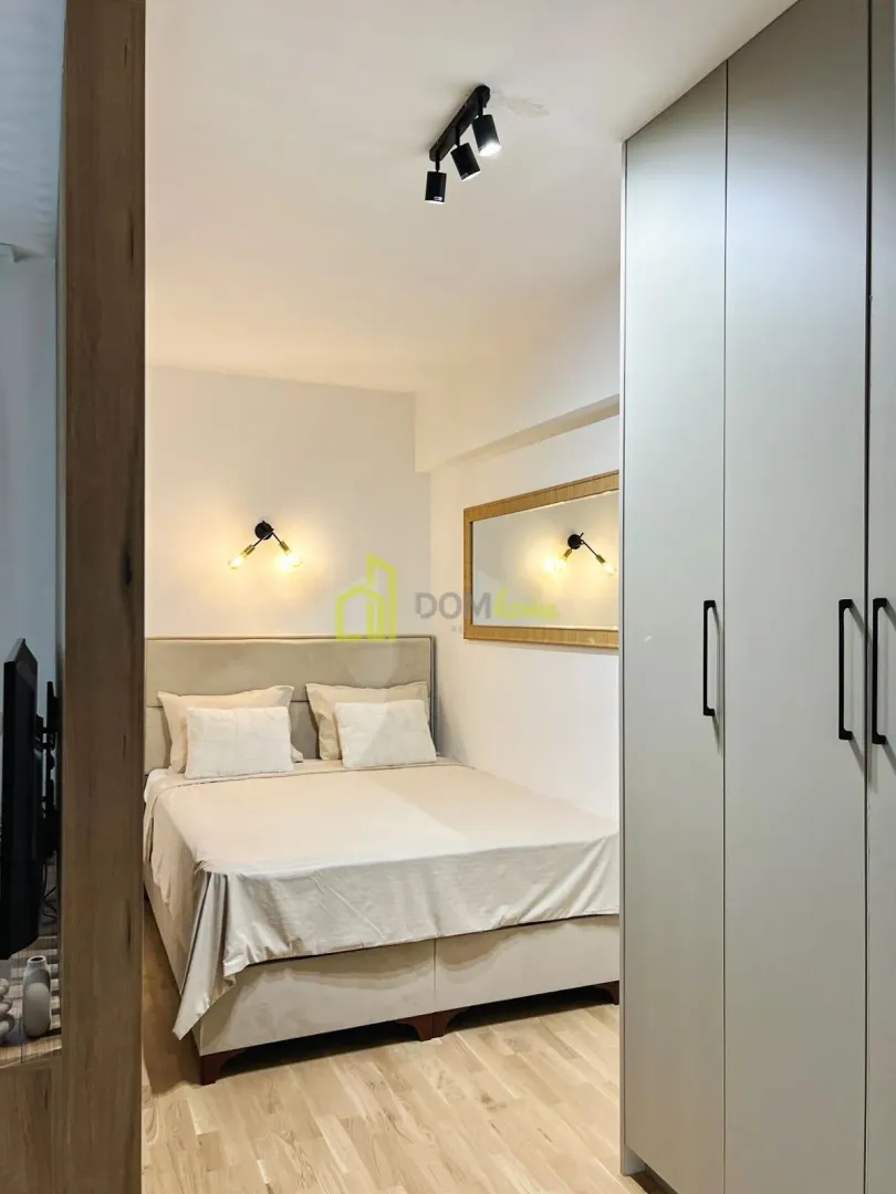 Modern bedroom with a double bed and a fitted wardrobe.