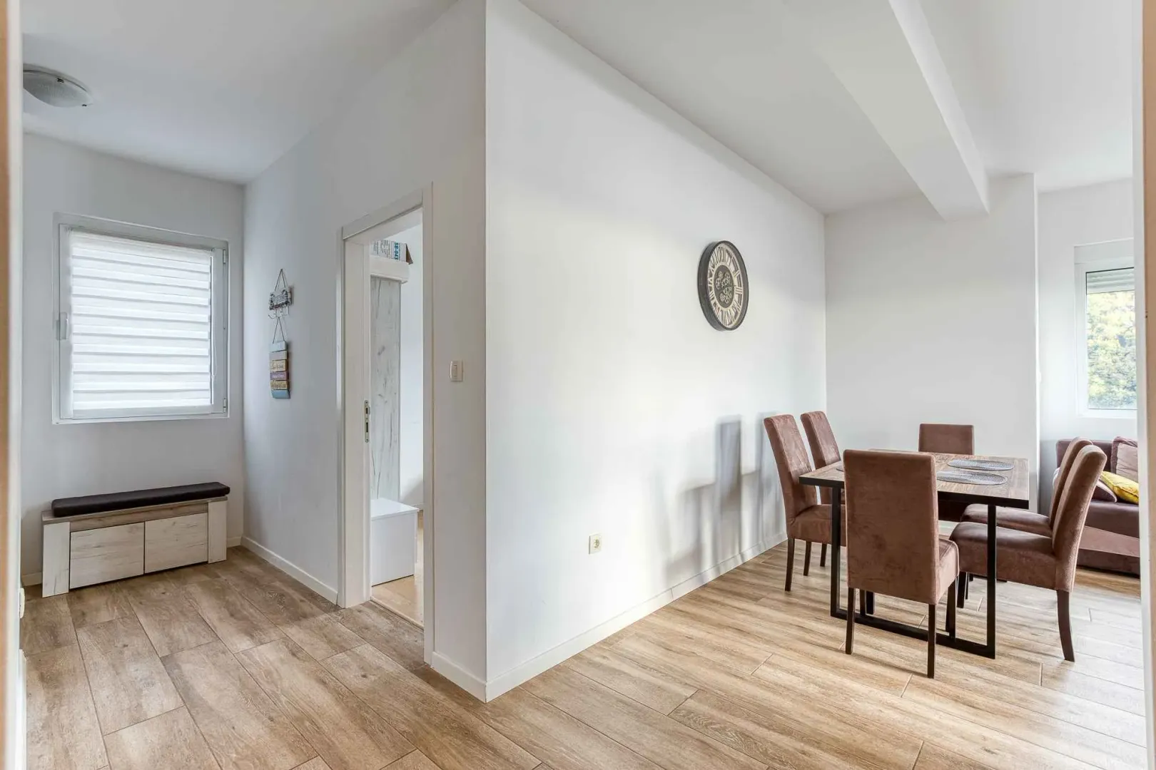Dining area with a dining table and chairs, connected to the living room.