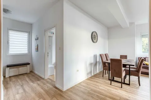 Dining area with a dining table and chairs, connected to the living room. - image 14