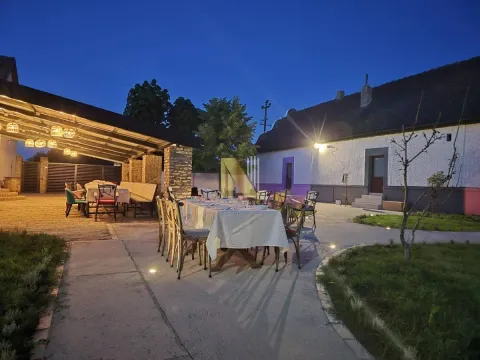 Večernji prikaz dvorišta sa trpezarijskim stolom i natkrivenom terasom. - image 5