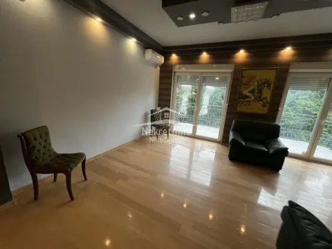 Spacious living room with wooden flooring, armchairs and access to the terrace. - image 4
