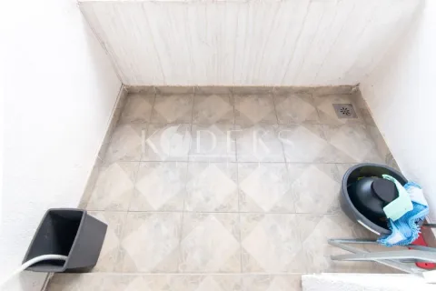 Small tiled balcony with cleaning supplies. - image 3