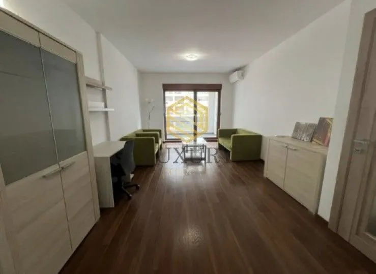 Living room with furniture, a desk, and access to the terrace.