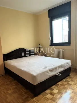 Bedroom with a double bed, parquet flooring, and a window. - image 14